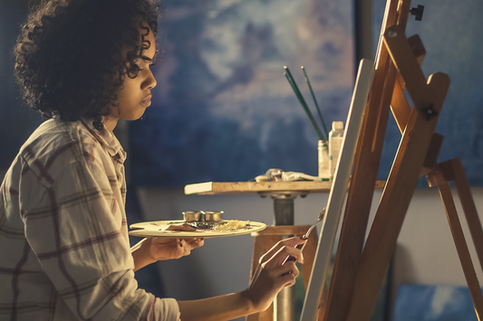 A woman painting, using her gift to fulfill her divine destiny. This image represents creativity and the empowerment that comes from embracing one's talents.